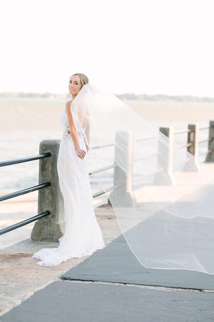 Charleston bridal portrait locations | Wind blowing veil at the charleston harbor