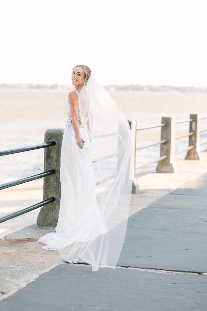 Charleston bridal portrait locations | Bride letting wind carry veil away 