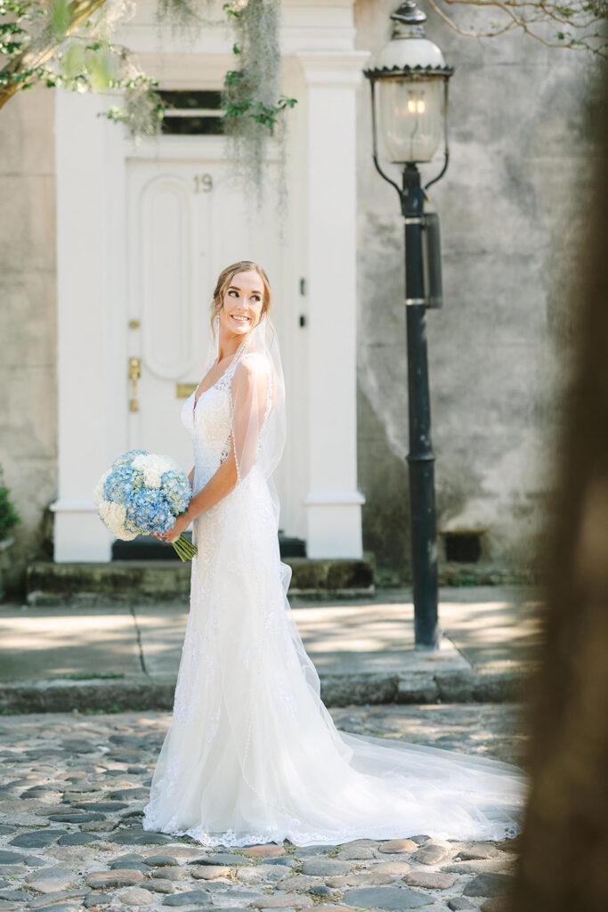 Charleston bridal portrait locations | bride looking away on cobblestone street