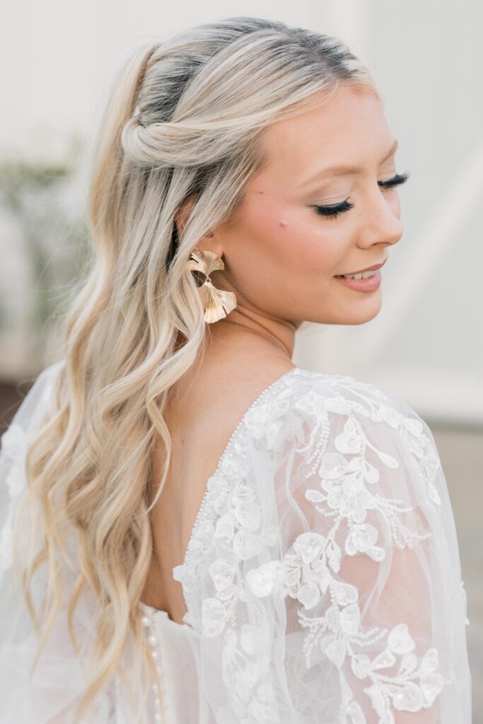 Bridal Portrait Mistakes | Bride closing eyes and showing off her bridal hair and makeup at Tin Roof Farms