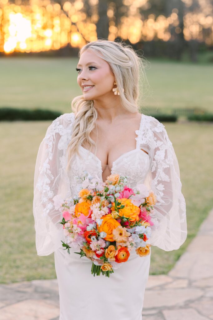 Bridal Portrait Mistakes | Bride at sunset looking off and holding a colorful bouquet