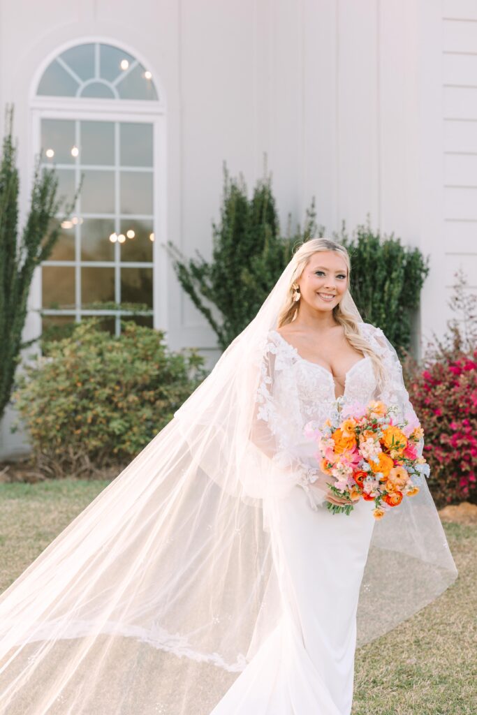 Bridal Portrait Mistakes | Beautiful bride holding bouquet and smiling in front of Tin Roof Farms