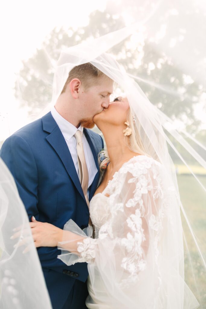 Columbia sc wedding photographer | Light and airy storytelling | Bride and groom kissing at Tin Roof Farms in Saluda SC