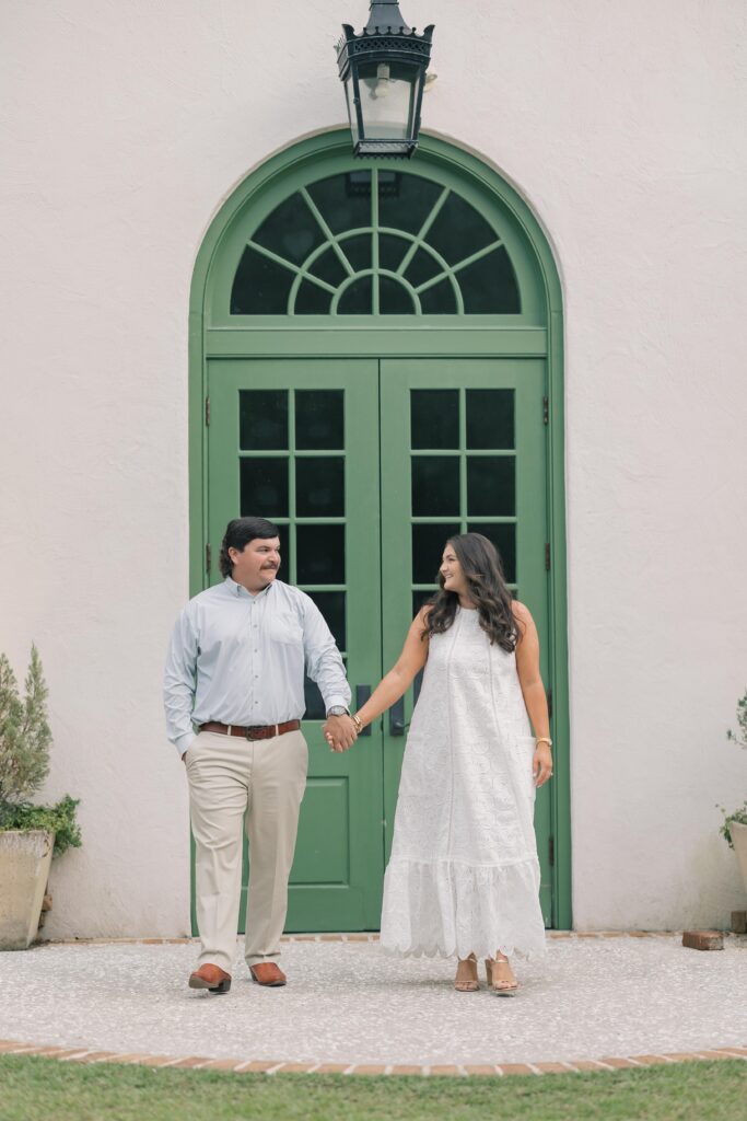 Charleston Wedding Photographer | Engagement Session at Creek at Ion |  couple walking in front of creek at ion chapel with big green door