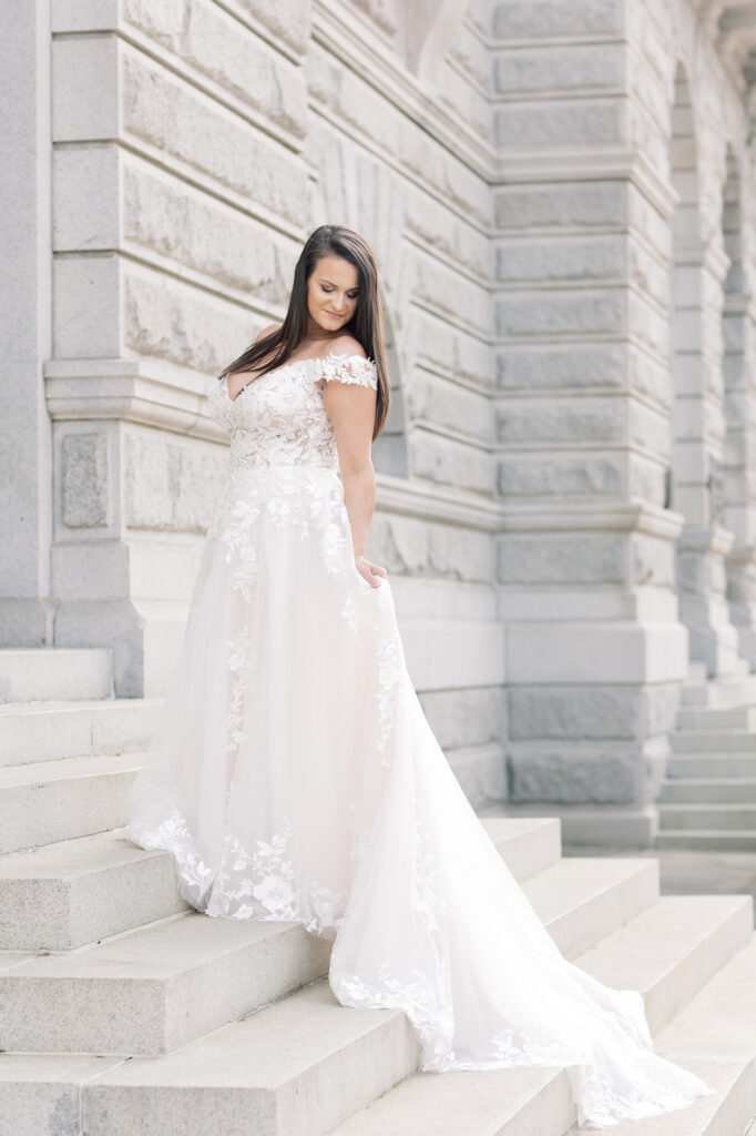 Bridal Portrait | Bride on the stairs of the charleston courthouse | Holding train down the stairs