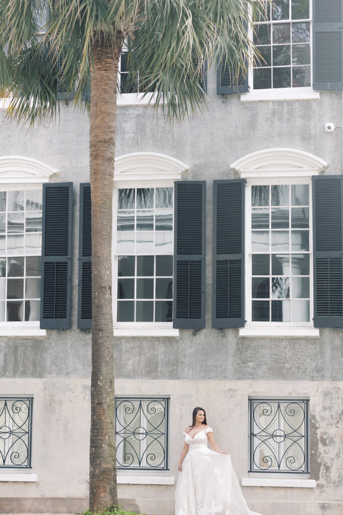 Bridal Portraits | Bridal portrait session in Charleston SC | bride standing by historic building looking out.