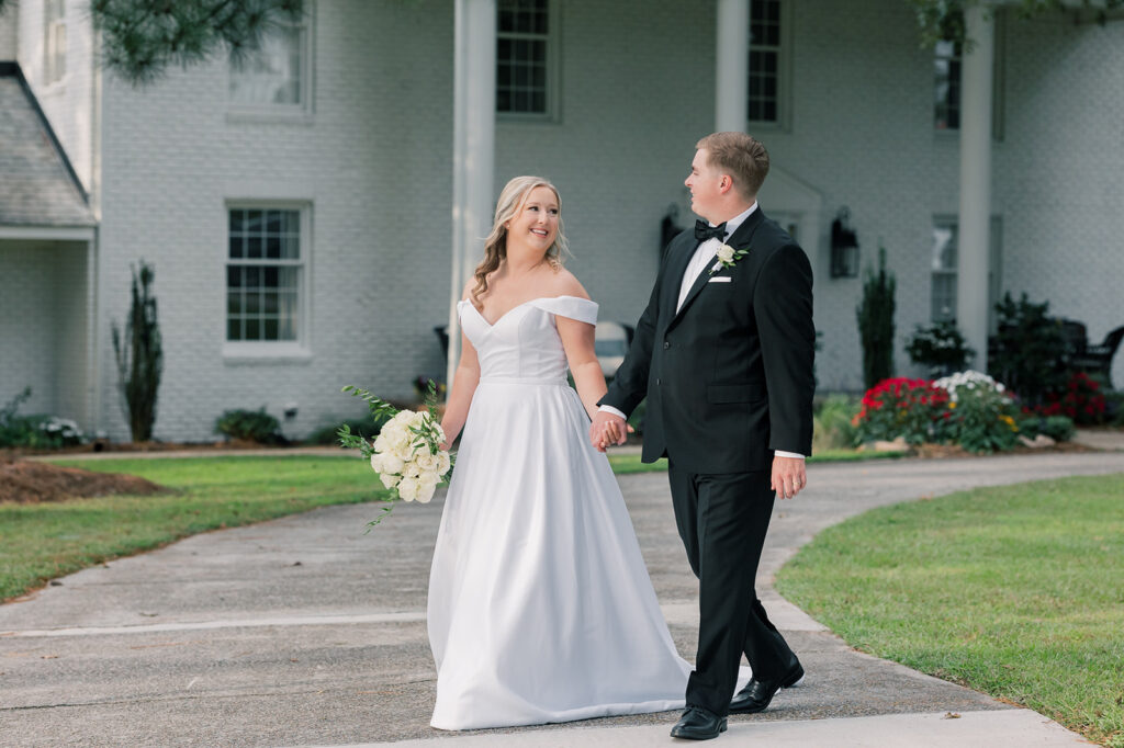 Heron Hill Wedding Venue | Gilbert SC | Chad and Kendall's wedding | Bride and groom holding hands and walking