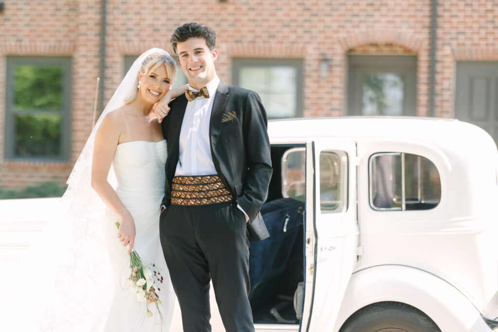 Columbia sc wedding photographer | Light and airy storytelling | close up of bride in groom standing in front of classic car at the laundry in columbia sc. 
