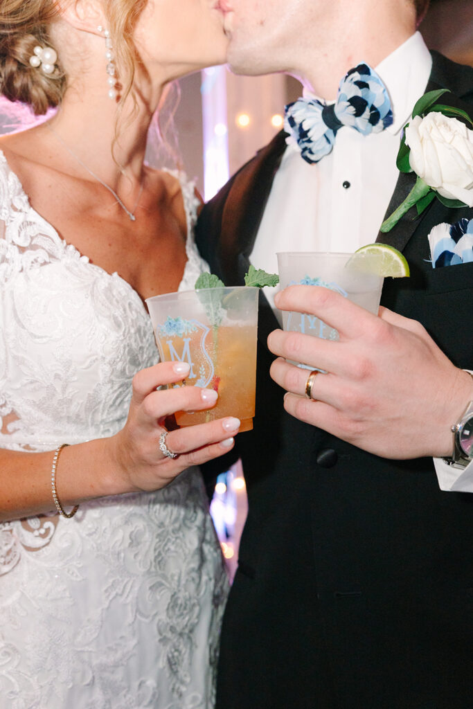The newlyweds hold colorful signature cocktails during their reception, adding a candid detail to their 701 Whaley wedding photos.