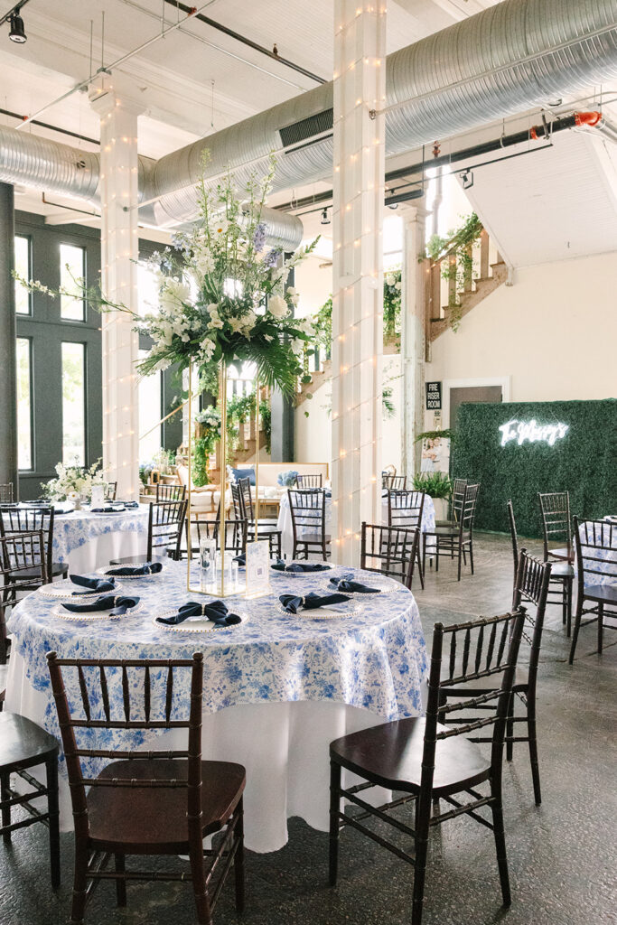 Wedding Photographers in Columbia SC | Stee Garman Photography Fine-art Wedding Photographer | Wedding reception venue with floral draped tables, elegant chairs, and glowing string lights on columns.