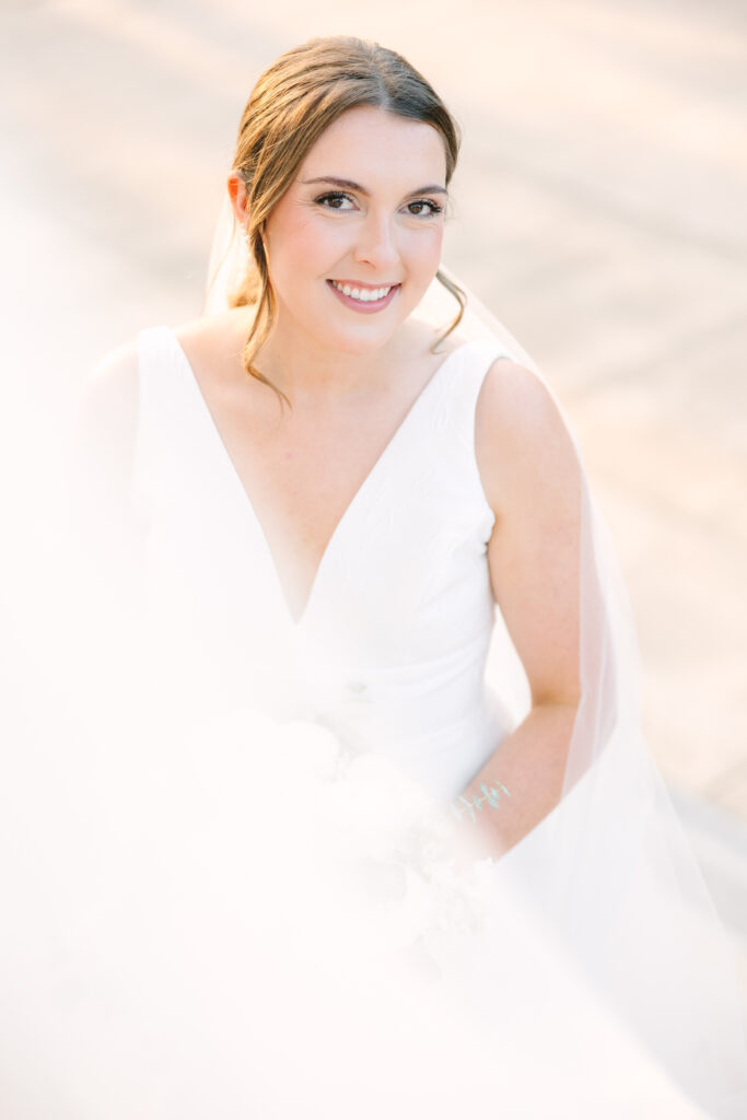 Soft, glowing portrait of a bride smiling toward the camera, highlighting natural light and skin tones that reflect the approach of top Columbia SC photographers.