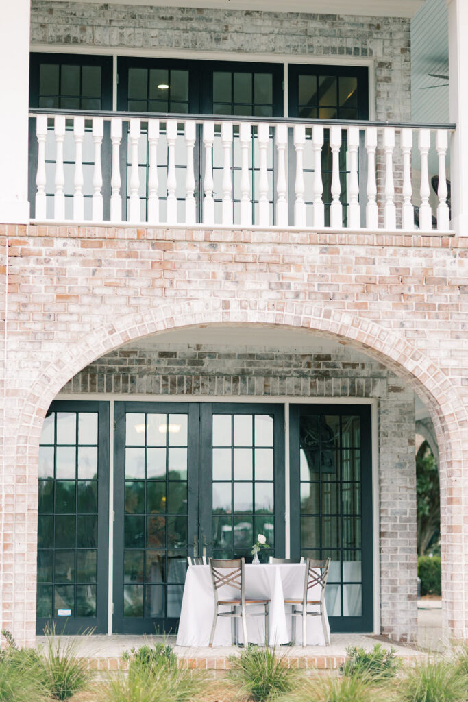 Brick archways and covered patio seating creating a polished outdoor entertaining space at a modern wedding venue in Columbia SC.