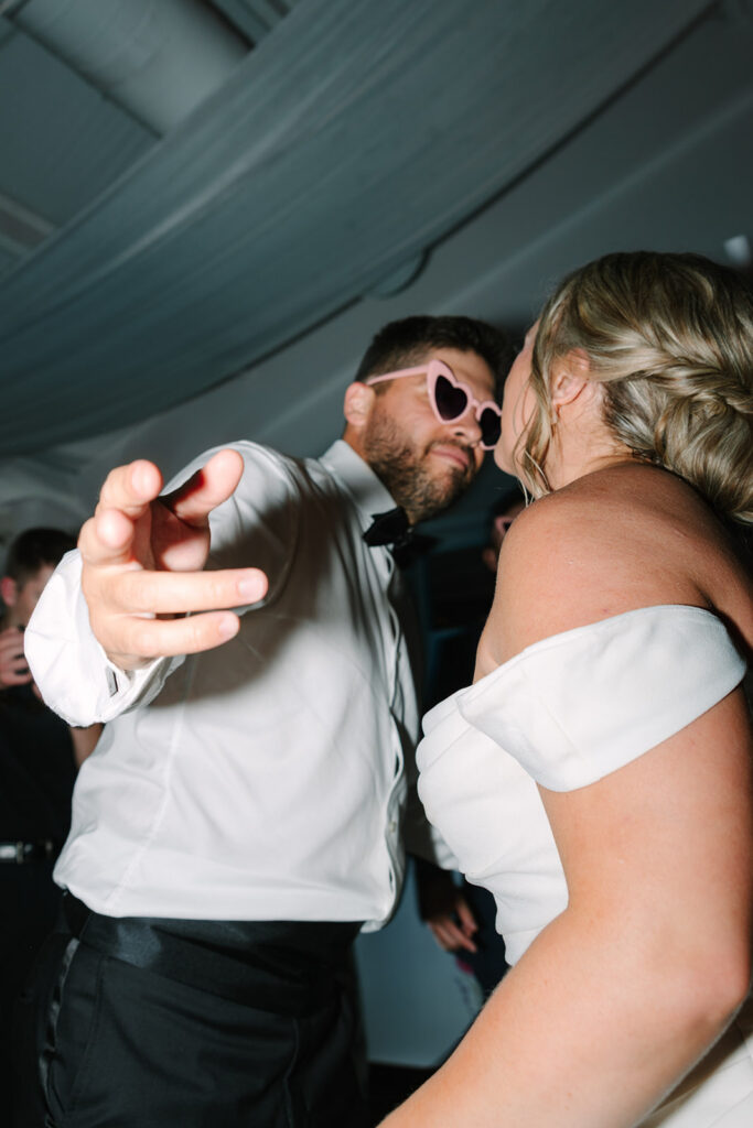 Guests dance under tented reception lighting as the celebration turns lively and joyful, reflecting the energy of a real wedding in Greenville SC.