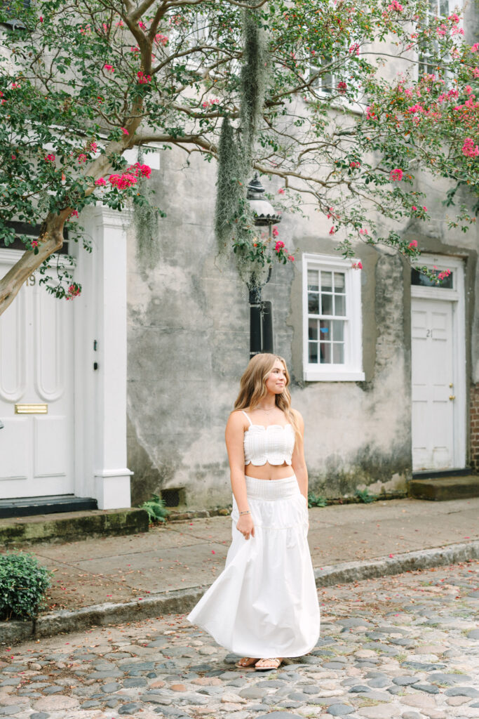 Senior walking on Chalmers Street in downtown Charleston, SC. Photographed by Stee Garman Photography.