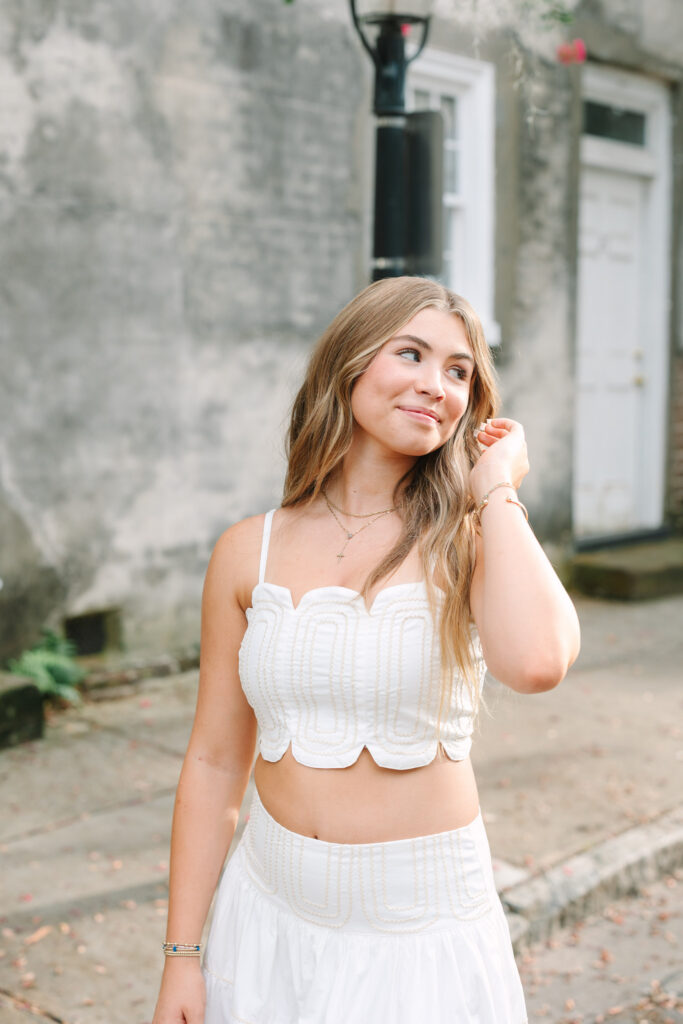 Senior posing on Chalmers Street in downtown Charleston, SC