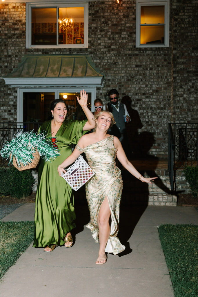 Wedding guests laughing and dancing outside the brick house at The Island House Charleston