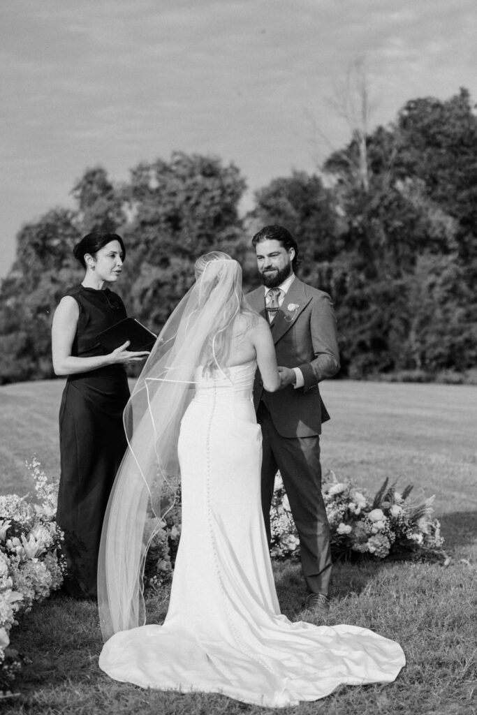 Black-and-white photograph of a couple exchanging vows at The Island House Charleston wedding