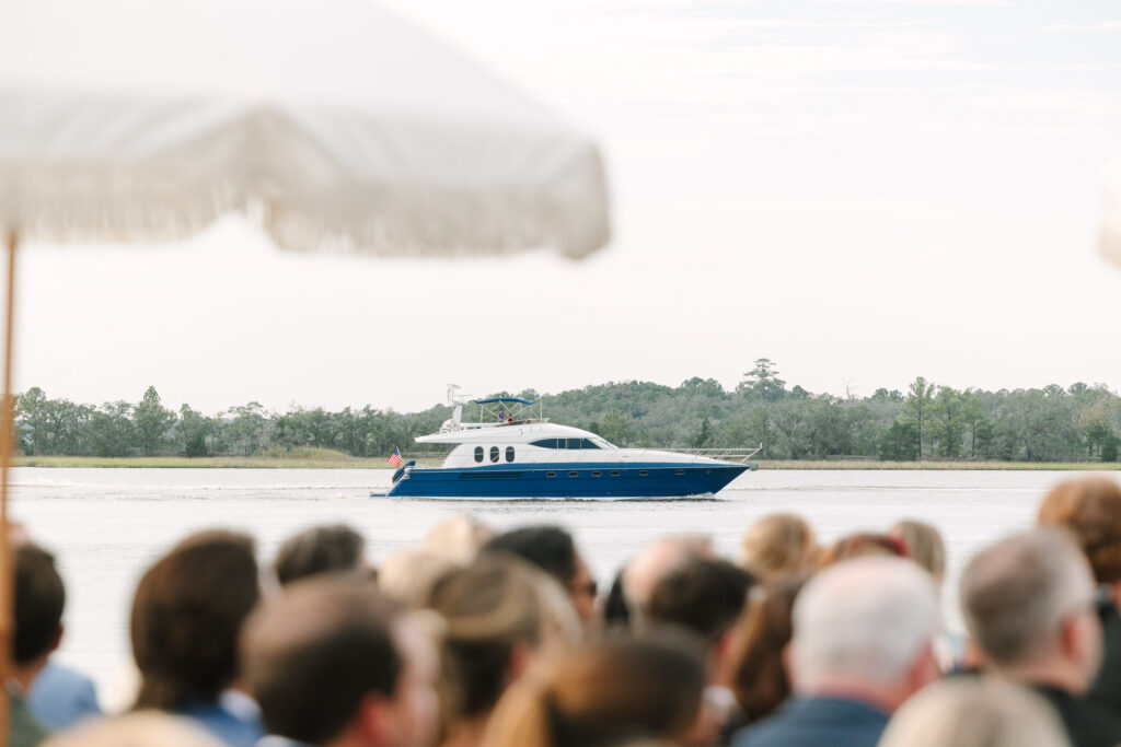 Yacht cruising along the Stono River during a waterfront wedding at The Island House