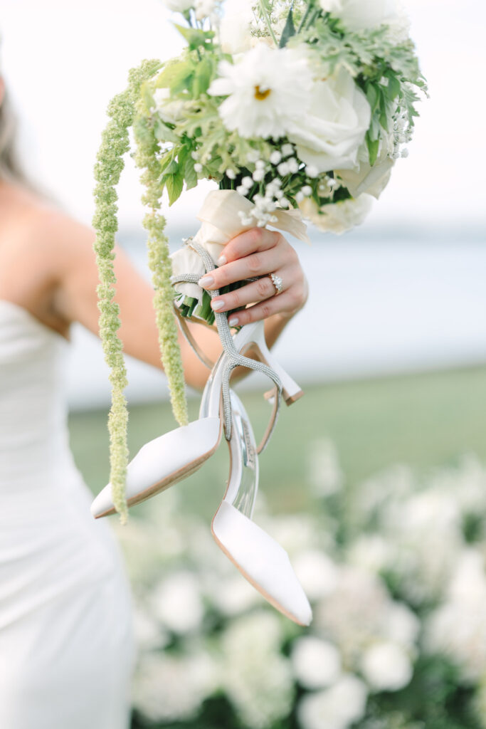 Close-up of a white bridal bouquet with trailing greenery and ribbon at The Island House wedding